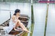 A woman sitting on a boat in the water.