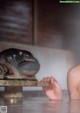 A person holding a piece of wood in the water.