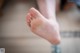 A close up of a person's bare foot on the floor.